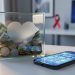 “A glass donation box with a heart-shaped cutout beside a smartphone with abstract responsible gaming icons, representing charitable initiatives and responsible online-casino play.”